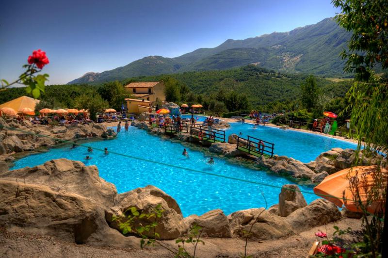 a large swimming pool with people in the water at LUCIA HOME CASA VACANZE in Santa Maria del Molise