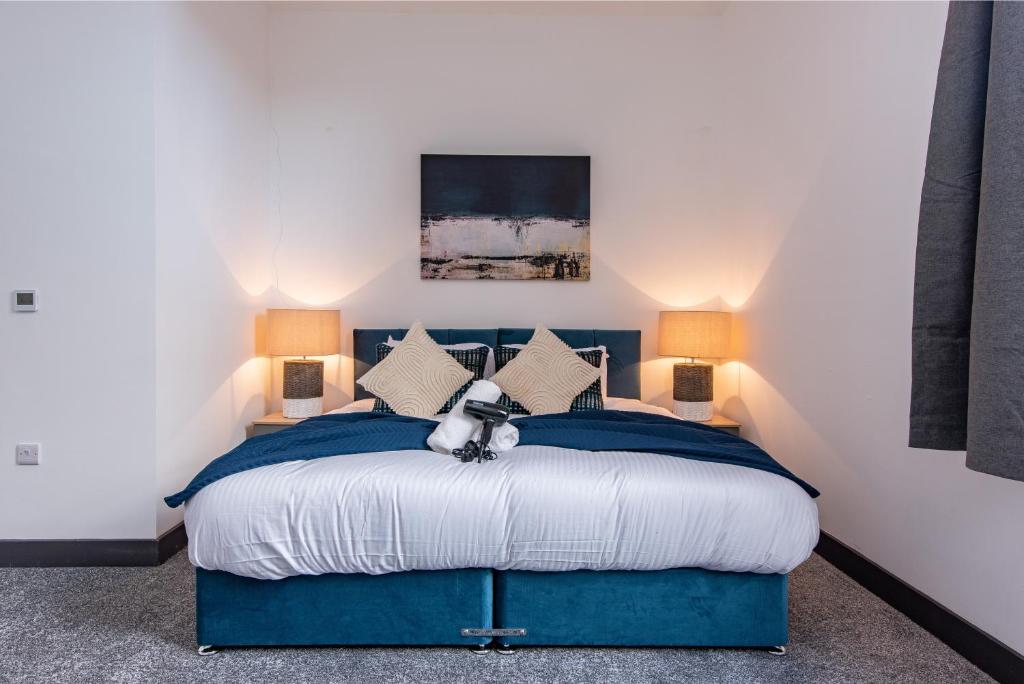 a bedroom with a blue bed with a teddy bear on it at Victoria Apartments: Contractor's Choice 3BR in Hartlepool in Hartlepool