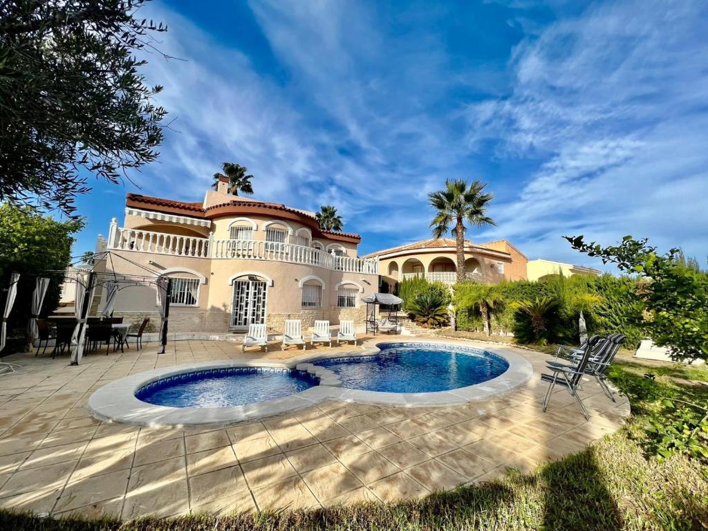 a house with a swimming pool in front of it at Villa Calma in Ciudad Quesada