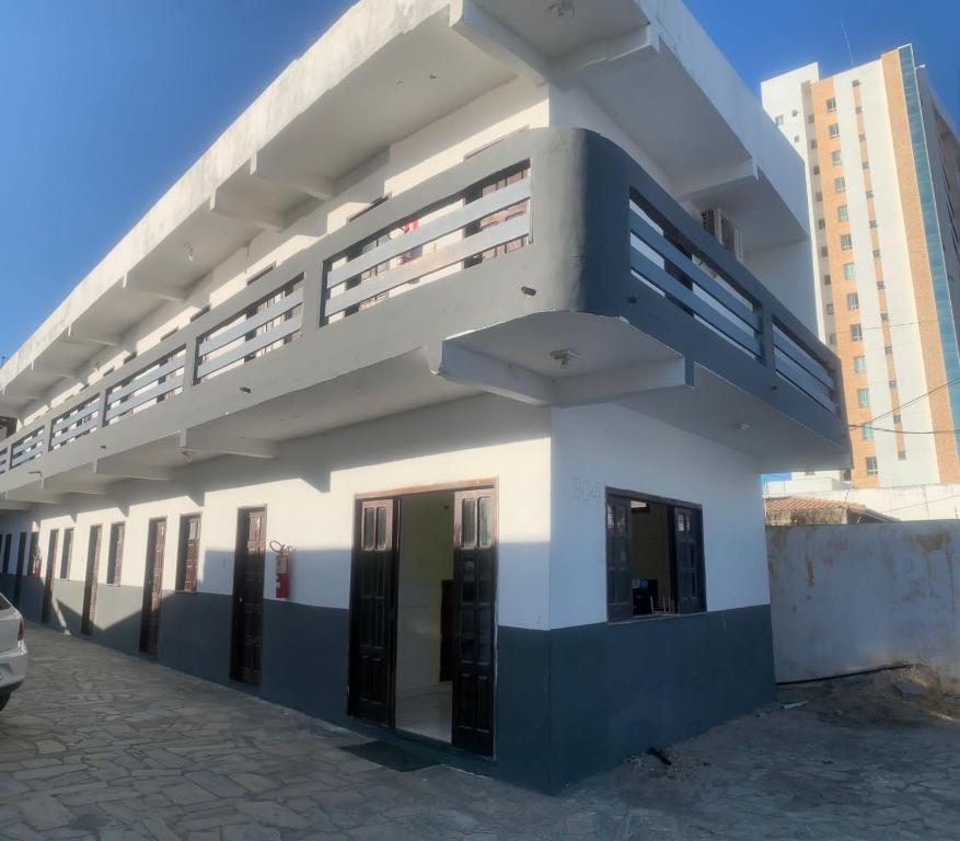 a white building with a staircase on the side of it at Pousada Mar Azul in Aracaju