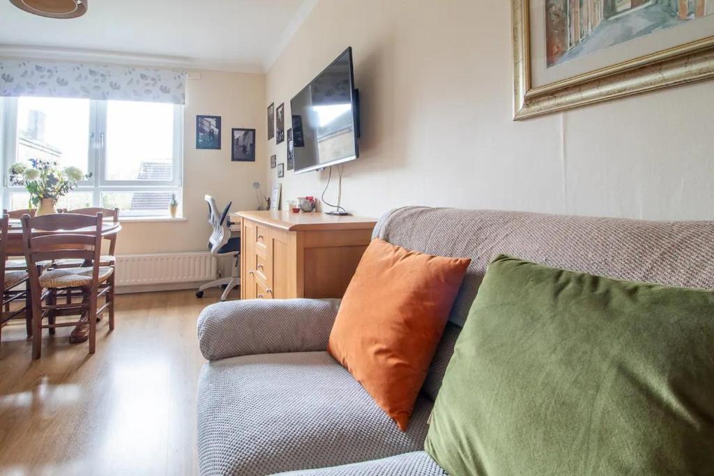 a living room with a couch and a table at Pass the Keys Prime Paisley with Parking in Paisley