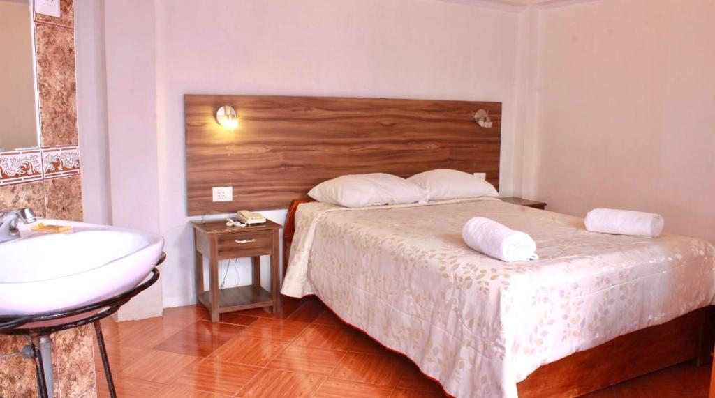 Postel nebo postele na pokoji v ubytování SAN BLAS PLAZA INn