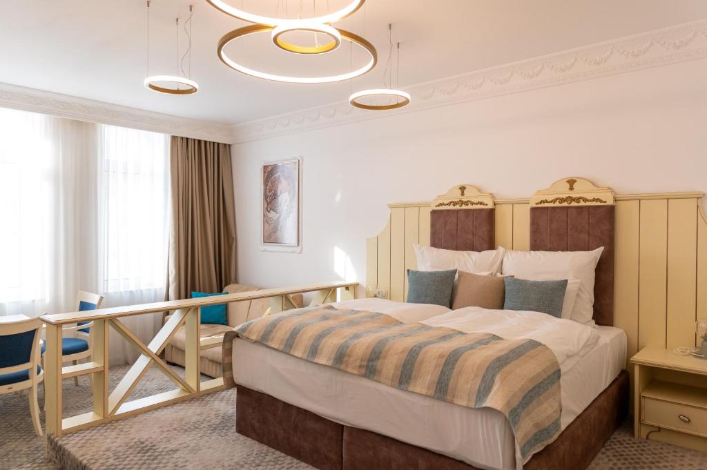 a bedroom with a large bed and a balcony at ATLAS HOUSE Luxury Suites in Plovdiv