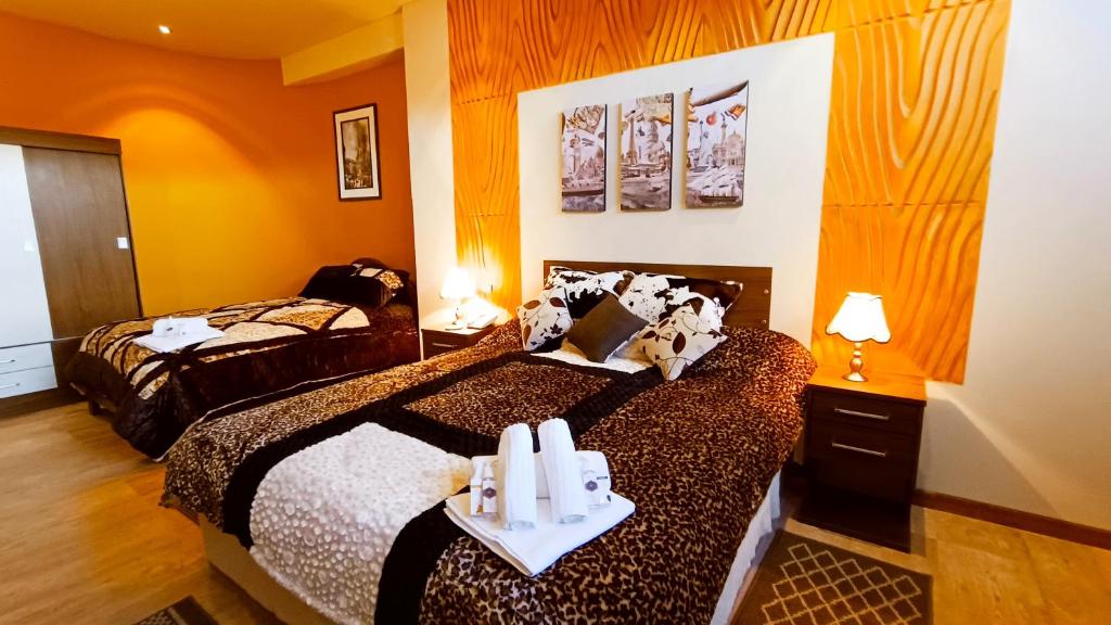 a hotel room with two beds with candles on them at HGA-Turquesa-Spa in La Paz