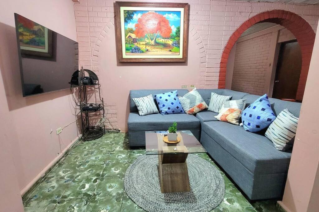 a living room with a blue couch and a table at Apartamento Maya y Mía in Santa Ana