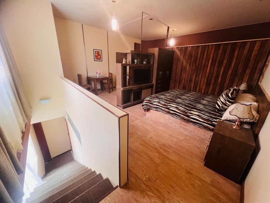 a view of a bedroom with a bed and a staircase at HGA-Ágata-Spa in La Paz