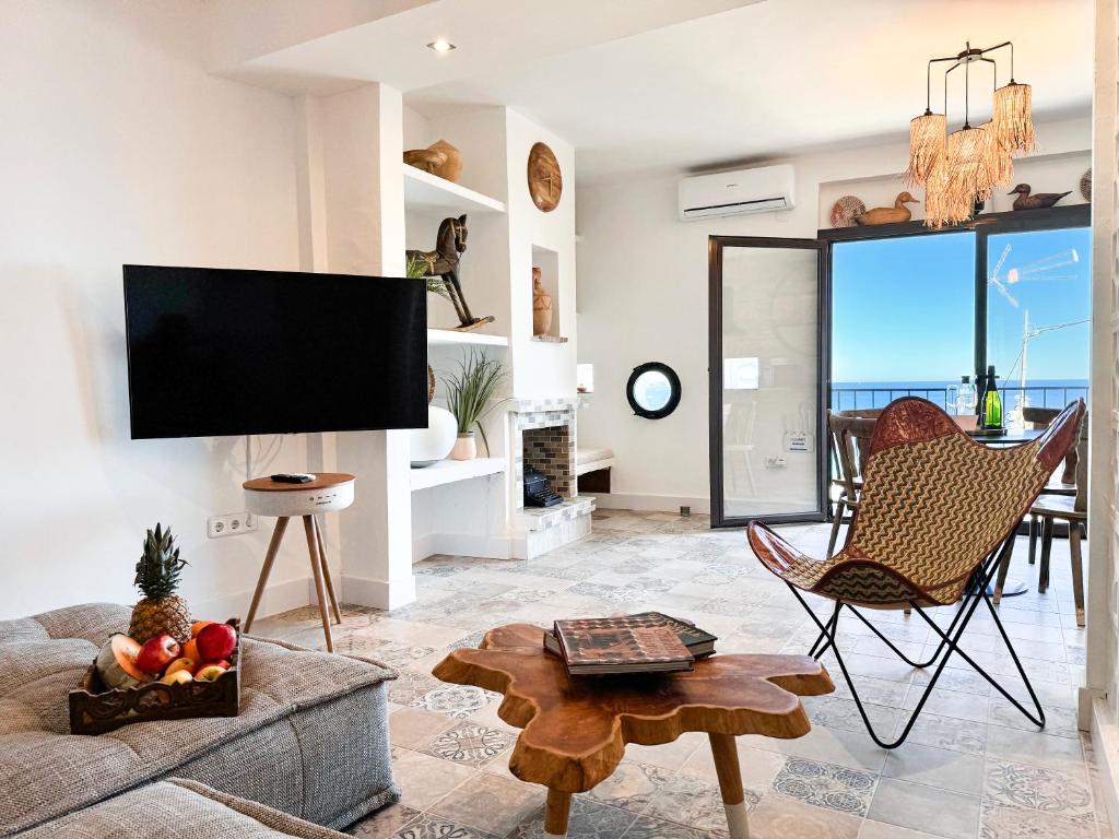 a living room with a couch and a tv at The Dreamer Balcón con Vistas al Mar by Vero in Altea
