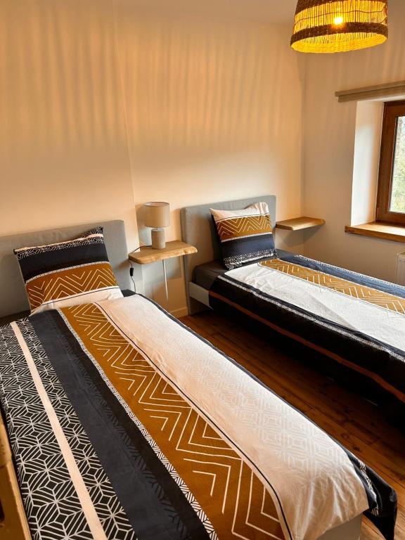 Postel nebo postele na pokoji v ubytování Gîte urbain L'Oneux