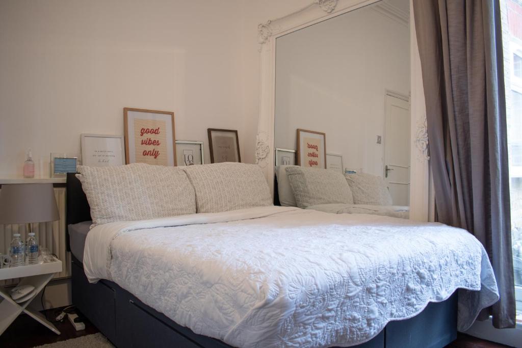 a bedroom with a large bed with a window at Private room with own entrance and bathroom in London