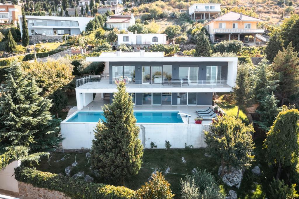 an aerial view of a house with a swimming pool at Sunrise - The Twin Villa by PikHost in Shirokë