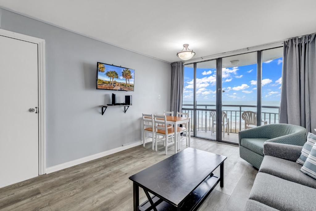 een woonkamer met een bank en een tafel bij Oceanfront Private Balcony Condo at Meridian Plaza in Myrtle Beach