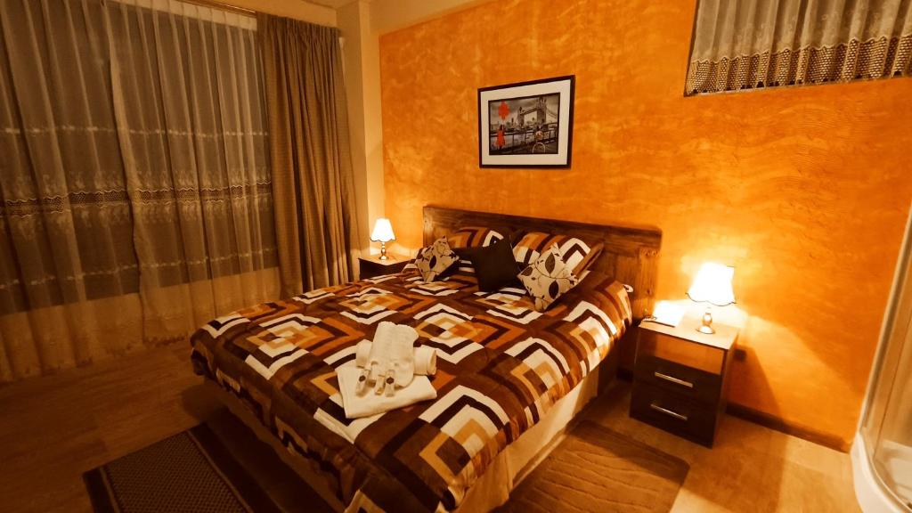 a hotel room with a bed with towels on it at HGA-Perla-Spa in La Paz