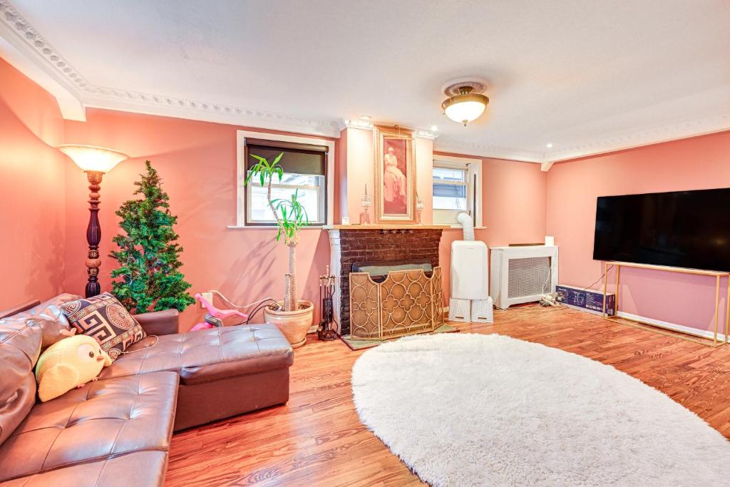 a living room with a couch and a television at Welcoming Glen Cove Home about 1 Mi to Public Beach! in Glen Cove