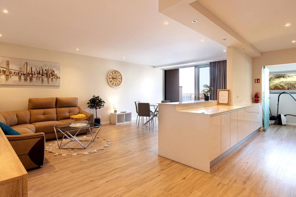 a kitchen and living room with a couch and a table at Luxury and modern apartment in Porto Moniz center in Porto Moniz