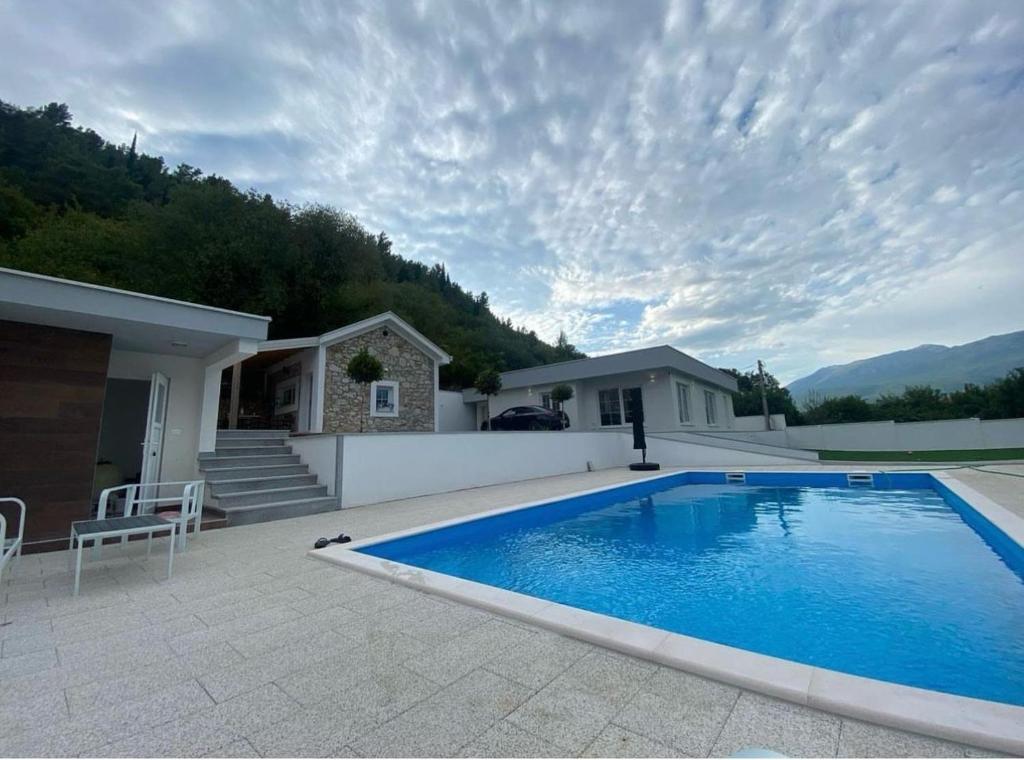 a large swimming pool in front of a house at Villa Aria in Mostar