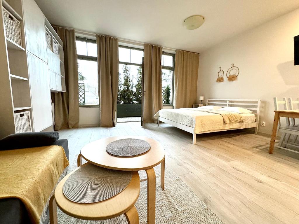 a bedroom with a bed and a table in a room at Apartamenty Marea Rentals Bulwar Portowy Ustka in Ustka