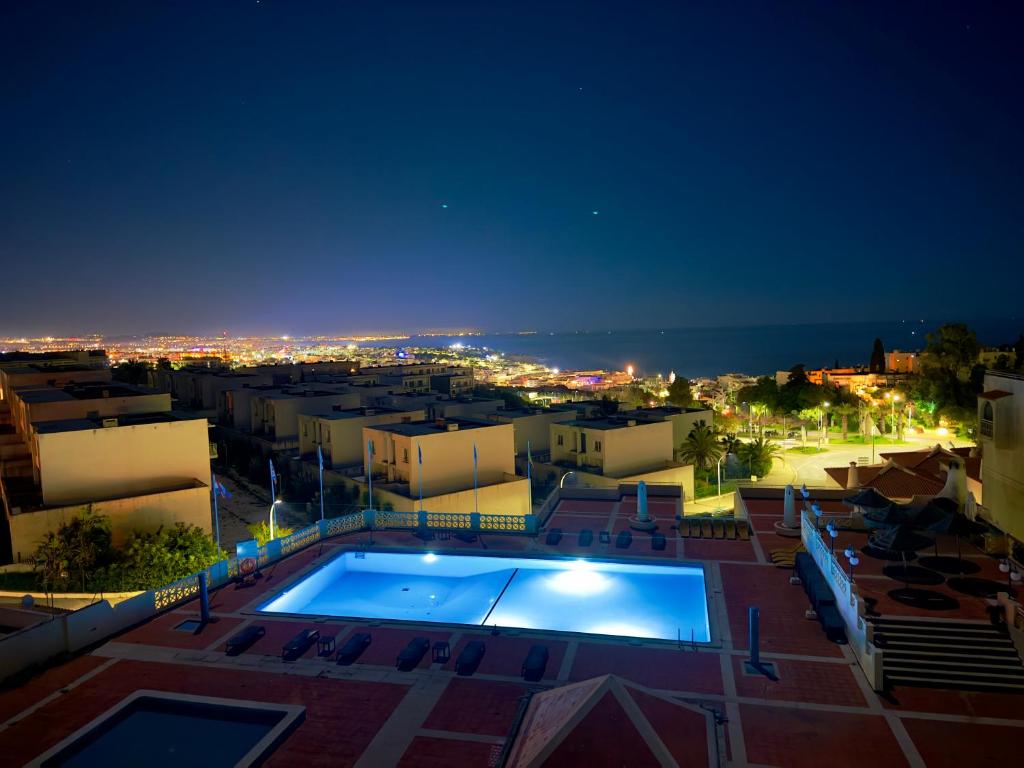a view of a city at night with a swimming pool at Apartment Les 3 Dauphins in Albufeira in Albufeira