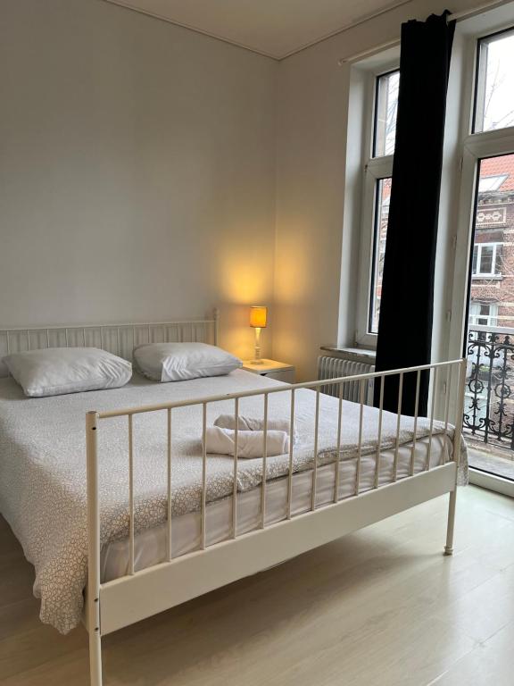 a bedroom with a bed and a window at Flat brussels center in Brussels