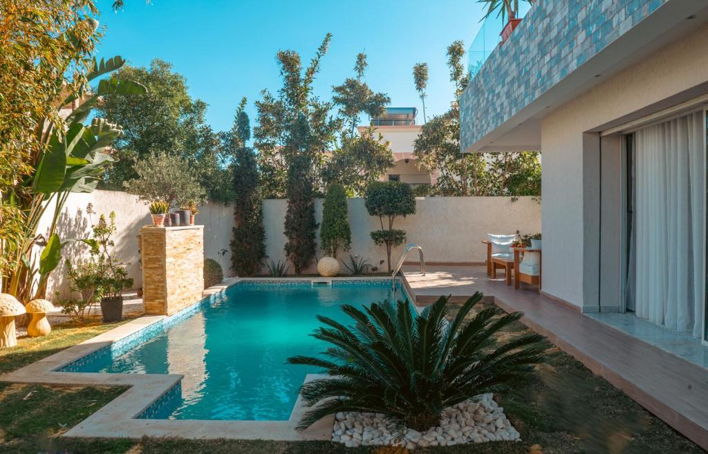 a swimming pool in the backyard of a house at Villa Victoria in Tunis