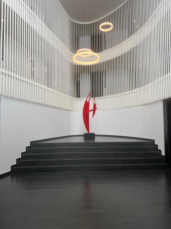 una escultura roja en un escenario en una habitación con escaleras en Palermo live en Buenos Aires