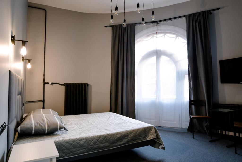 a bedroom with a bed and a large window at BESLEV in Tallinn