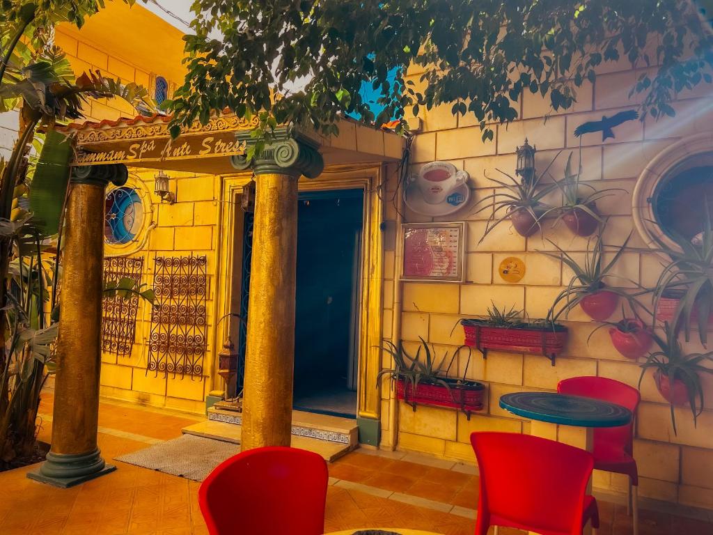 a restaurant with red chairs and a table at Hammam Antistress in Sousse