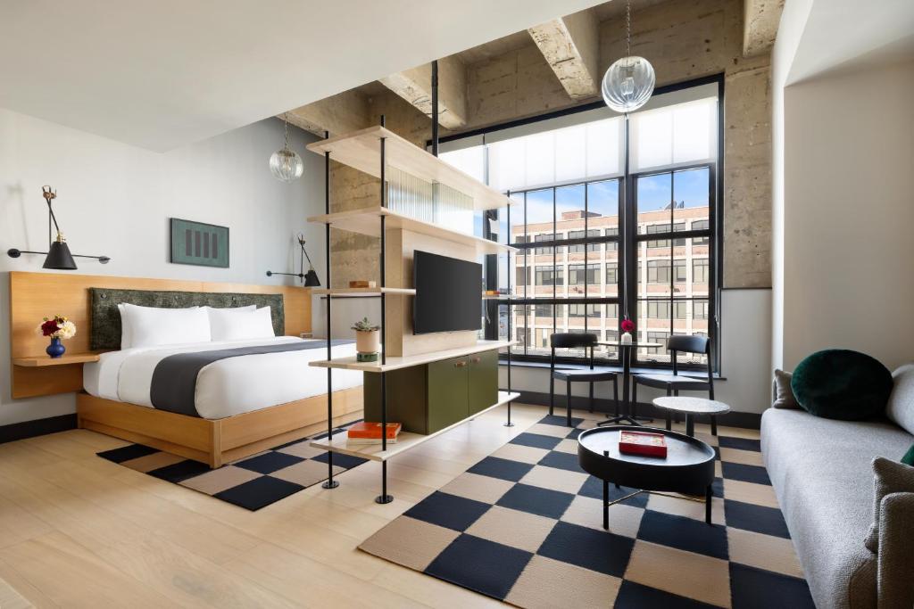 a bedroom with a bed and a living room at Switch House Hotel in Philadelphia