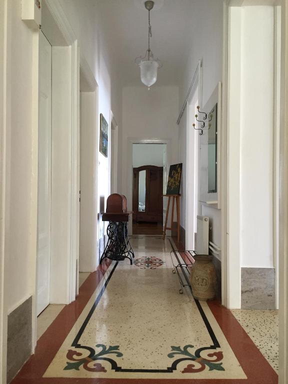 a hallway with white walls and a rug on the floor at Villa Peppina Apartment in Lovran