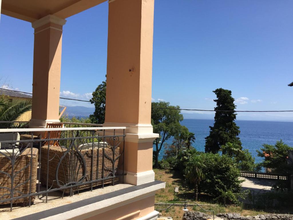 a balcony with a view of the ocean at Villa Peppina Apartment in Lovran