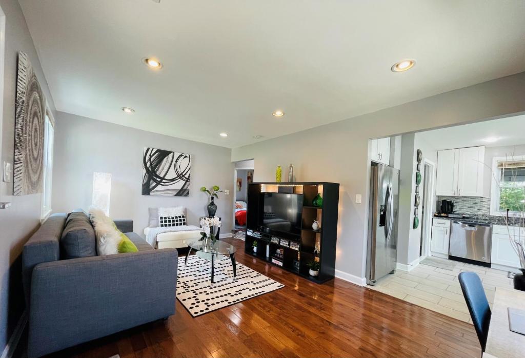 a living room with a couch and a tv at Modern & Spacious-walk to metro w/ parking On-site in Silver Spring