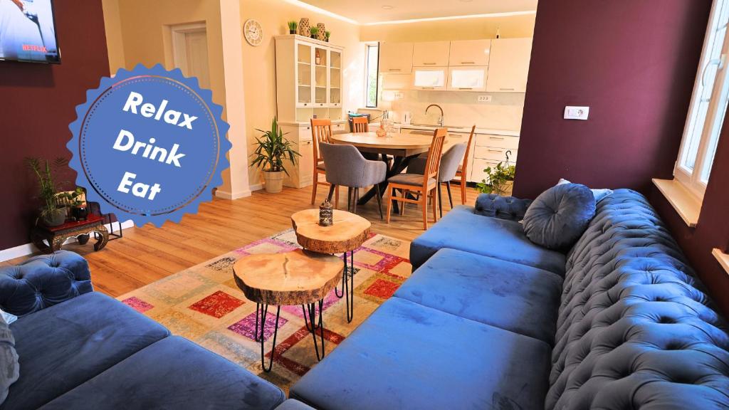 a living room with a blue couch and a table at Central single house with parking-TOP LOCATION! in Novalja