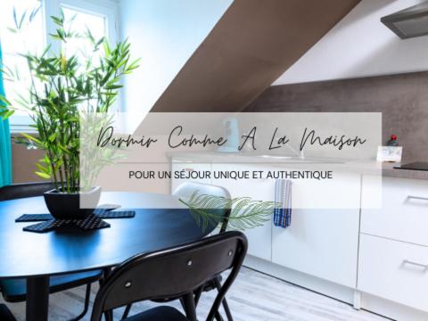 a blue table with plants on it in a kitchen at Au coucher de soleil - Dormir comme à la maison - in Châteaubriant