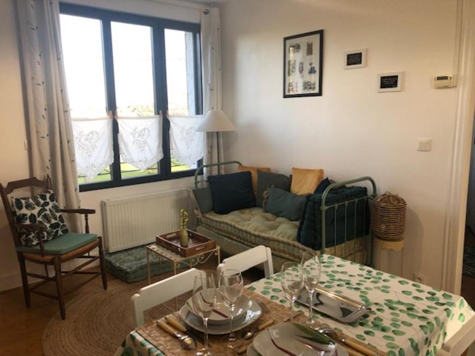 a living room with a couch and a table at Les Hortensias in Amiens