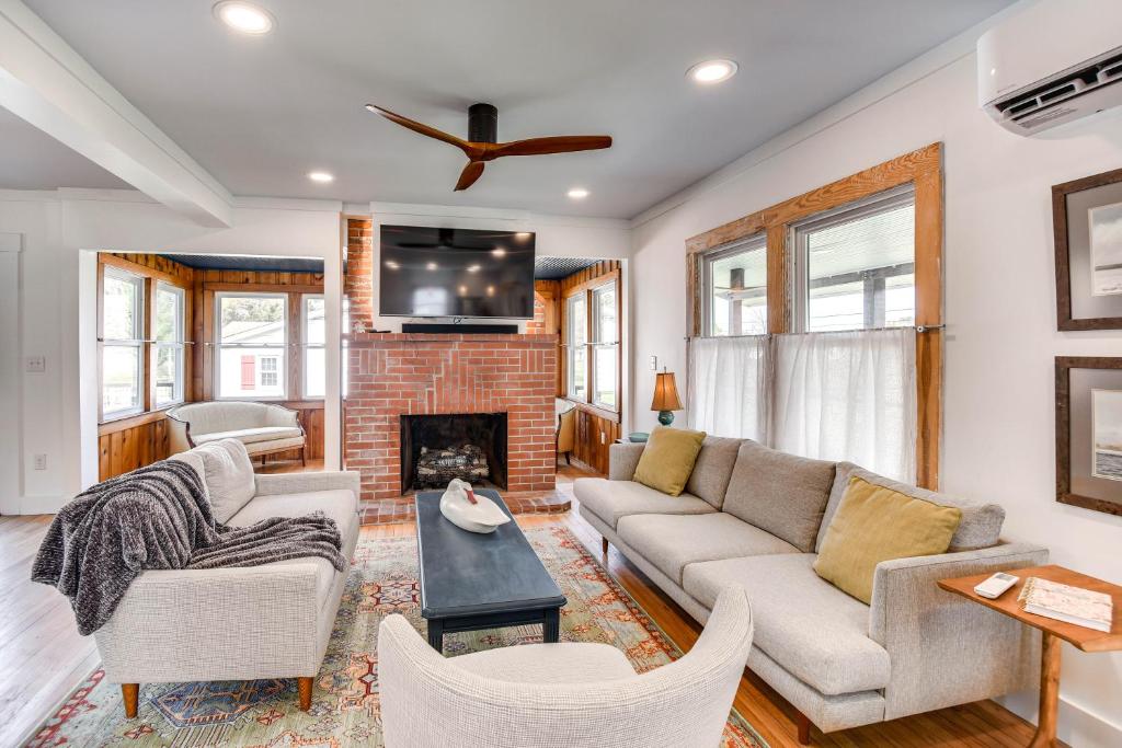 a living room with a couch and a fireplace at Virginia Retreat with Porch and Grill, Near Beaches! in Wachapreague