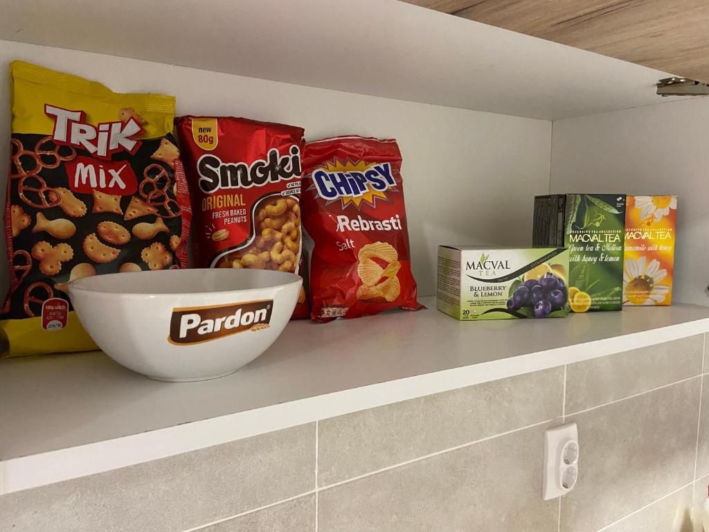 a shelf with a bowl of food and other snacks at Kula Dream apartment in Kula