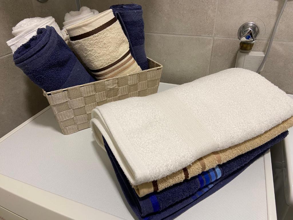 a pile of towels sitting on a counter in a bathroom at Kula Dream apartment in Kula