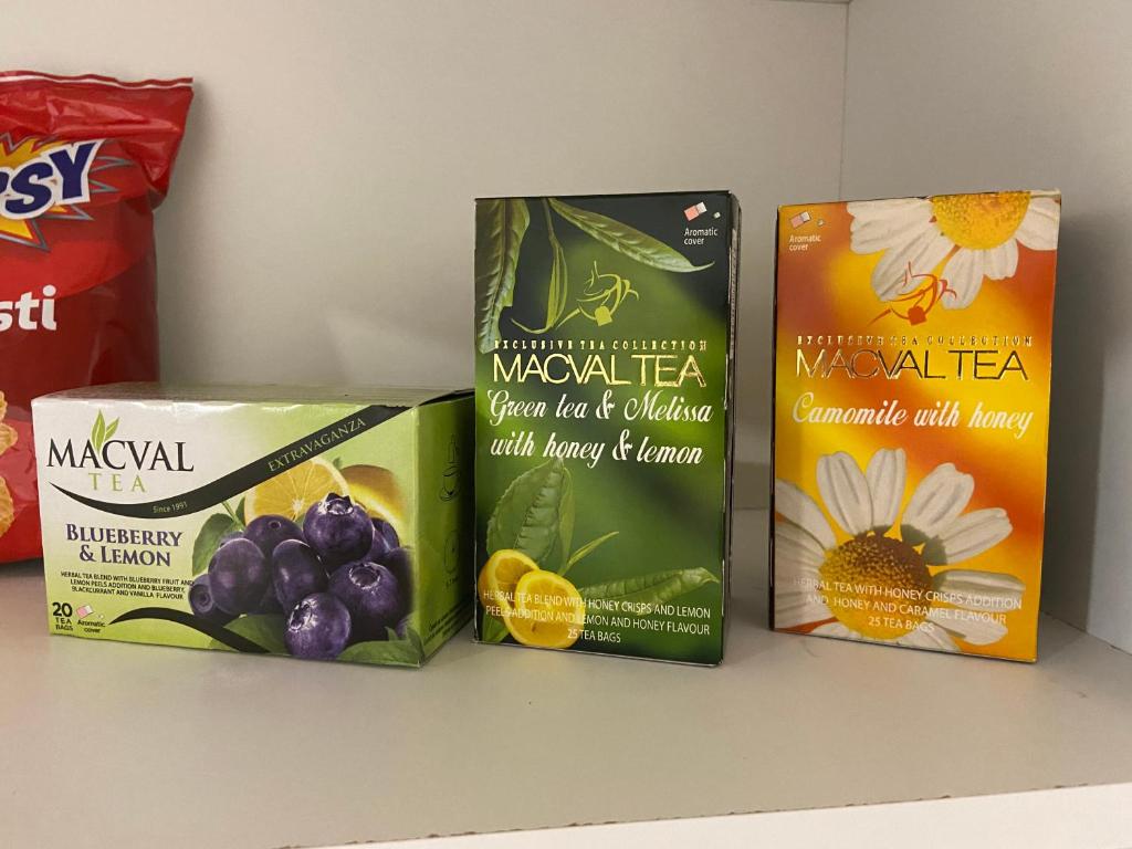 three boxes of food sitting on a shelf at Kula Dream apartment in Kula