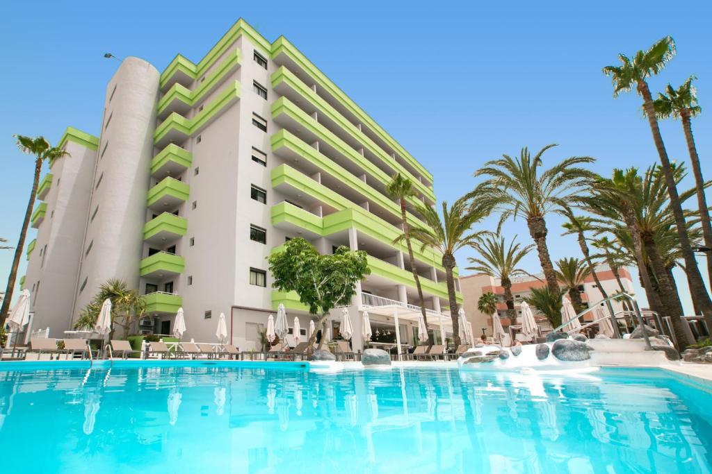 a swimming pool in front of a hotel at Hotel LIVVO Anamar Suites in Playa del Ingles