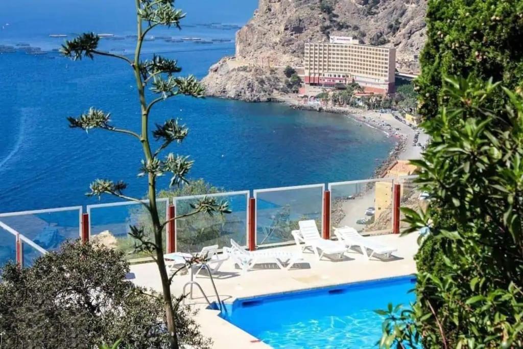 a view of a beach from a resort with a swimming pool at El Espejo del Mar in Almería