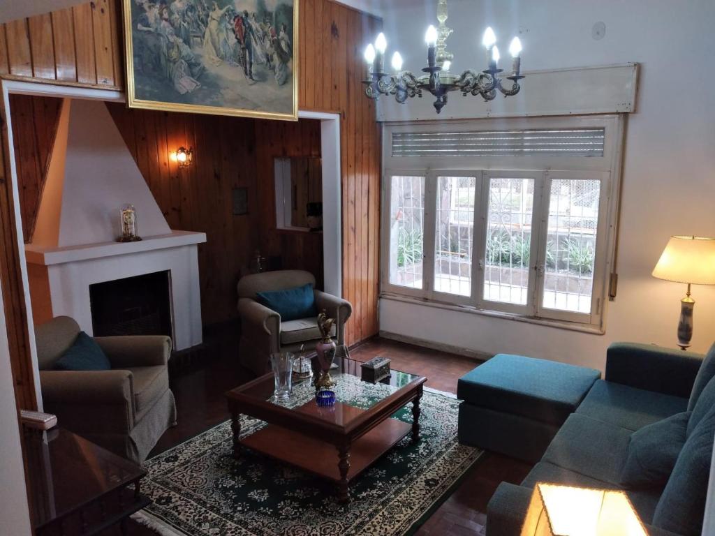 a living room with a couch and a table at La Dorada , Casa entera en Excelente Zona Residencial con cochera techada in Rosario
