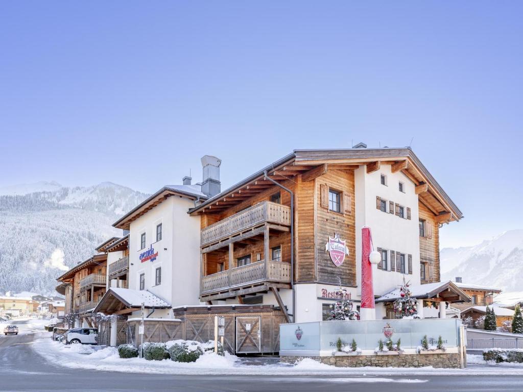 a large building with snow on the ground at Mountainview in Kaprun