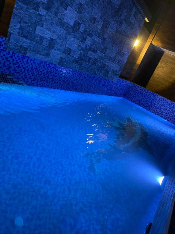 a large swimming pool with blue water at night at CHEZ EL HADJI NGOR in Dakar