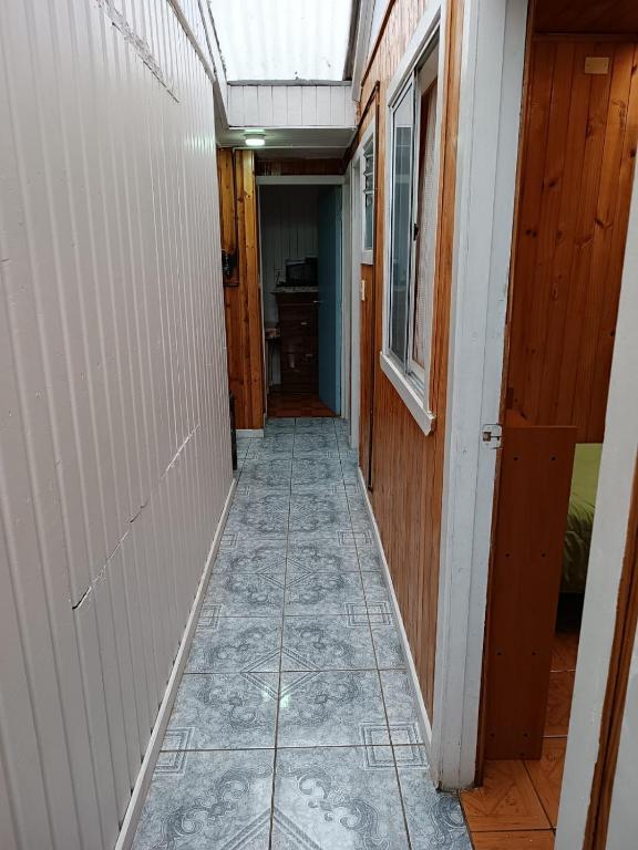 a hallway of a house with a tile floor at Cabaña Interior con entrada independiente in Osorno