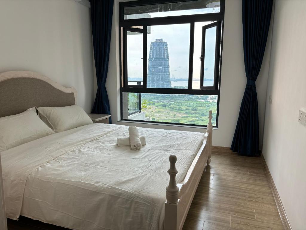 a bedroom with a bed and a large window at Ataraxia park condo forest city in Gelang Patah