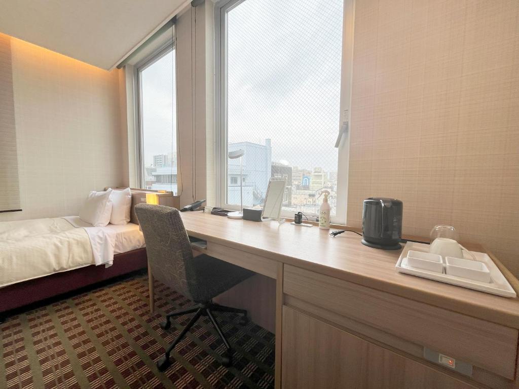 Postel nebo postele na pokoji v ubytování Garden Hotel Shizuoka