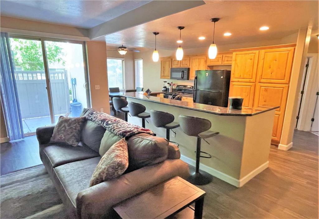 a living room with a couch and a kitchen at 3-Bedroom Luxury Condo in the Heart of the City in Salt Lake City