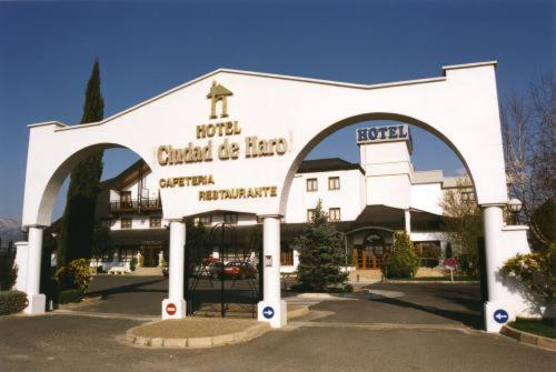 a large white building with an arch entrance at Ciudad de Haro in Haro