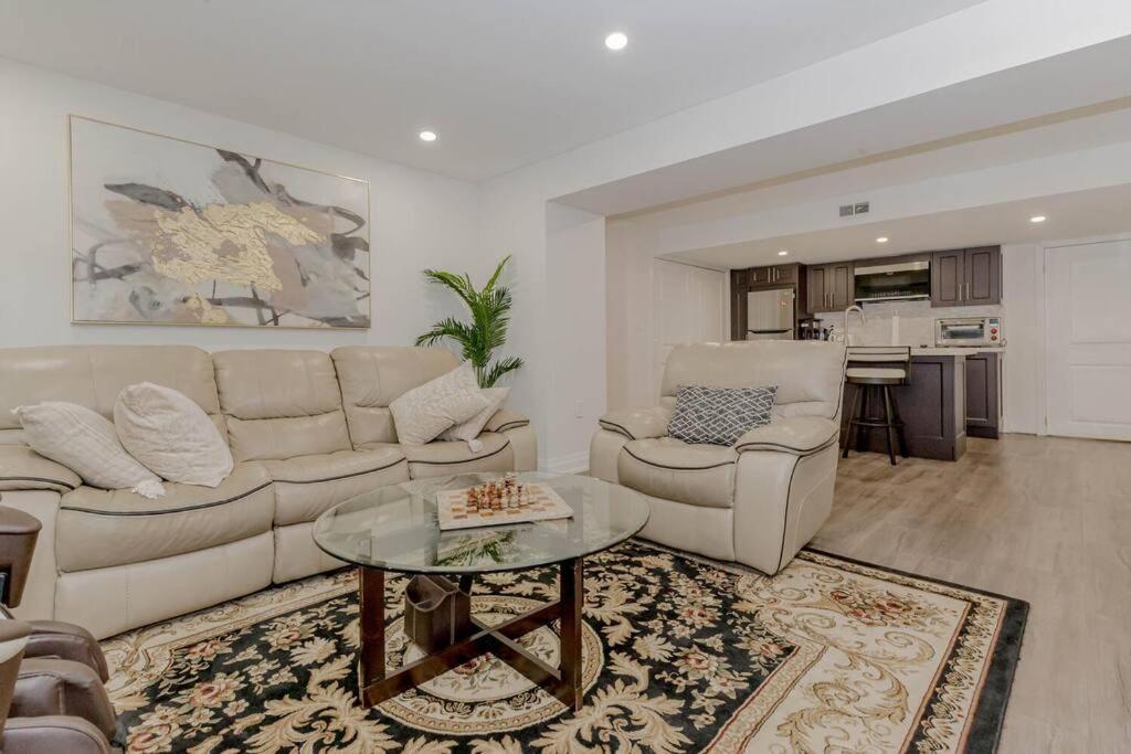 a living room with a couch and a table at Luxury Basement Apartment in Oakville in Oakville