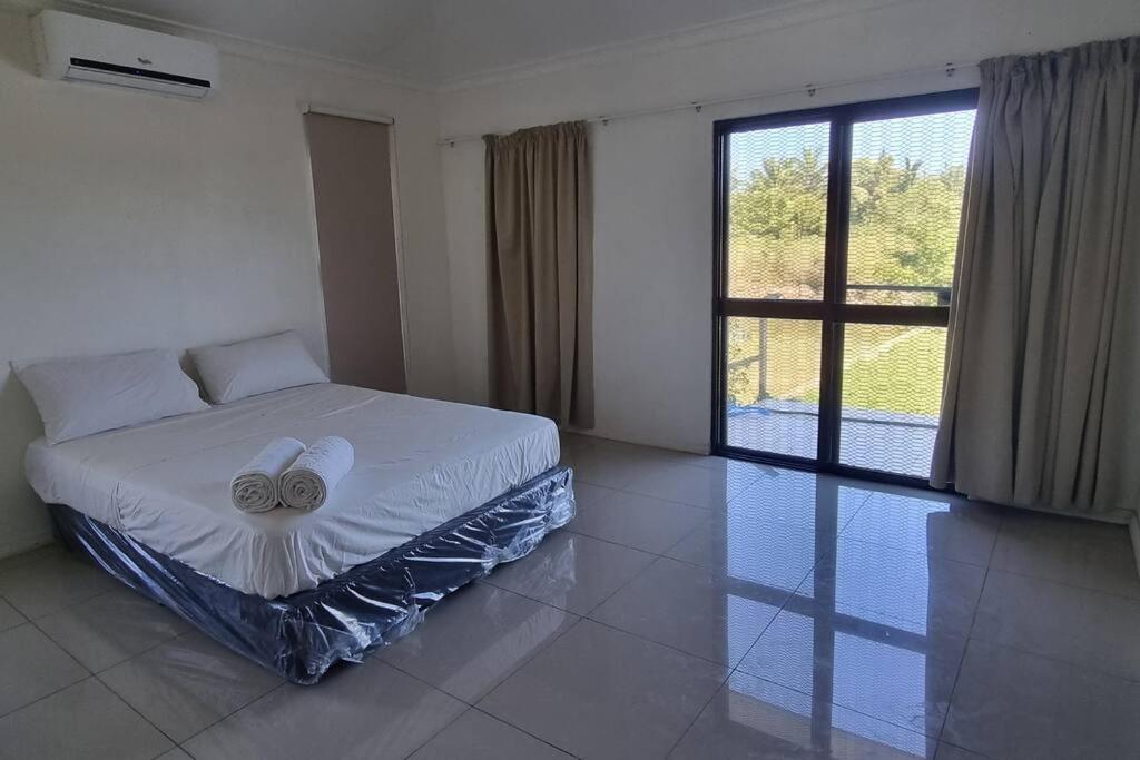 a bedroom with a bed and a large window at Large 4 bedroom villa with Pool in Sonaisali Nadi in Nadi