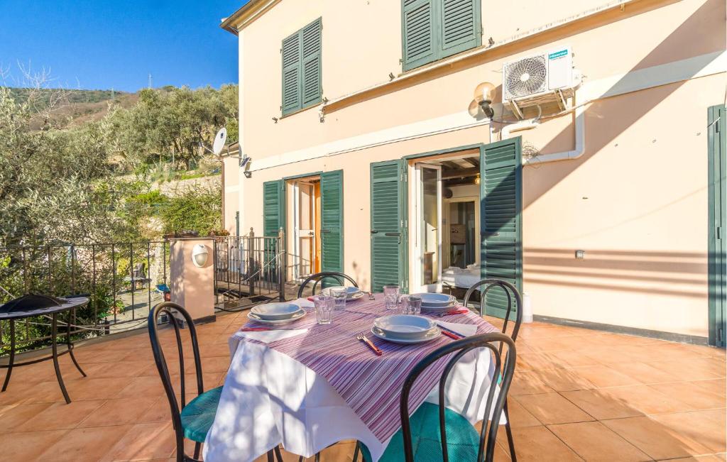 a table with plates on it on a patio at Stunning Apartment In Recco With Outdoor Swimming Pool, 1 Bedrooms And Wifi in Recco